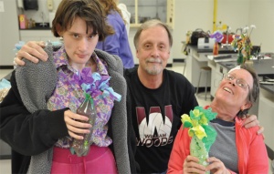 Terry Martin and his new friends display the flowers resulting from an art therapy session in 2011. (Photo by Maddie Meyer)